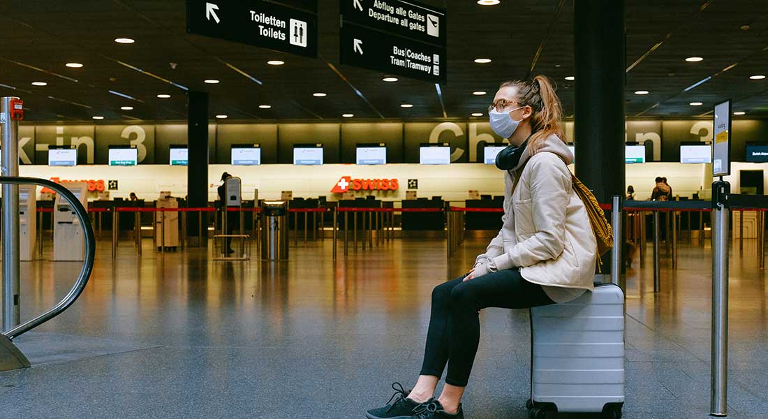 Woman sitting on luggage